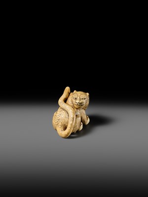 Lot 151 - A POWERFUL OSAKA SCHOOL IVORY NETSUKE OF A CROUCHING TIGER