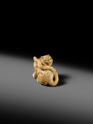 Lot 151 - A POWERFUL OSAKA SCHOOL IVORY NETSUKE OF A CROUCHING TIGER
