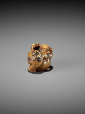 Lot 330 - MASATAMI: A CHARMING LACQUERED IVORY NETSUKE OF A BOY CLIMBING ATOP A DRUM