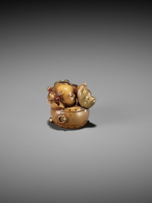 Lot 330 - MASATAMI: A CHARMING LACQUERED IVORY NETSUKE OF A BOY CLIMBING ATOP A DRUM