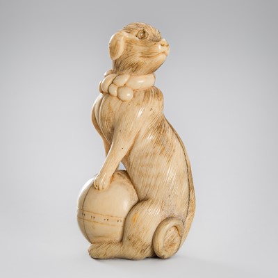 Lot 1541 - AN IVORY NETSUKE OF A DOG, c. 1800s