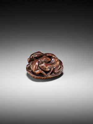 Lot 205 - ISSAN: A FINE WOOD NETSUKE OF SUMO WRESTLING FROGS ON A LOTUS LEAF