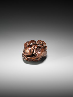 Lot 205 - ISSAN: A FINE WOOD NETSUKE OF SUMO WRESTLING FROGS ON A LOTUS LEAF