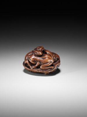 Lot 205 - ISSAN: A FINE WOOD NETSUKE OF SUMO WRESTLING FROGS ON A LOTUS LEAF