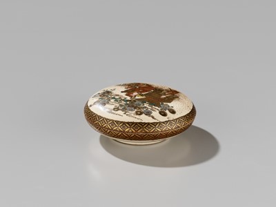 Lot 223 - KYOZAN: A FINE SATSUMA CERAMIC KOGO (INCENSE BOX) AND COVER DEPICTING MONKEYS WITH A FLOWER BASKET