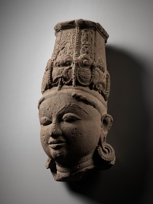 Lot 239 - A LARGE PINK SANDSTONE HEAD OF VISHNU, NORTHERN OR CENTRAL INDIA, 10TH-11TH CENTURY