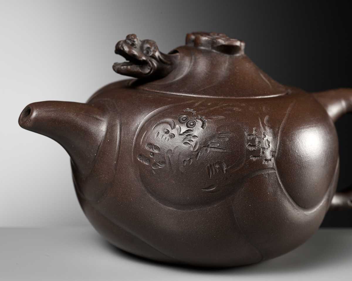 Lot 1384 - A YIXING STONEWARE 'DRAGON AND CARP' TEAPOT