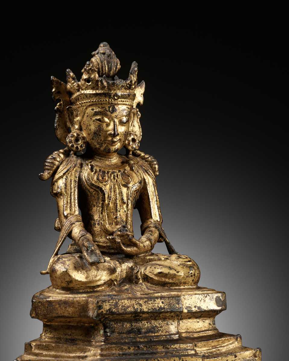 Lot 693 AN ARAKAN STYLE GILT BRONZE FIGURE OF BUDDHA