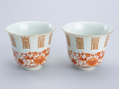 Lot 1334 - A PAIR OF IRON-RED AND GILT PORCELAIN CUPS, GUANGXU MARK AND PERIOD