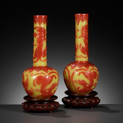 Lot 366 - A PAIR OF CARVED RED-OVERLAY YELLOW GLASS BOTTLE VASES, 18TH-19TH CENTURY