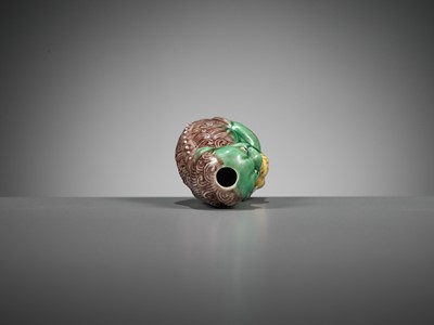 Lot 387 - A MOLDED AND SANCAI-GLAZED PORCELAIN ‘LION AND CUB’ SNUFF BOTTLE, 1790-1830