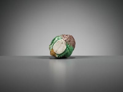 Lot 387 - A MOLDED AND SANCAI-GLAZED PORCELAIN ‘LION AND CUB’ SNUFF BOTTLE, 1790-1830