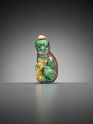 Lot 387 - A MOLDED AND SANCAI-GLAZED PORCELAIN ‘LION AND CUB’ SNUFF BOTTLE, 1790-1830