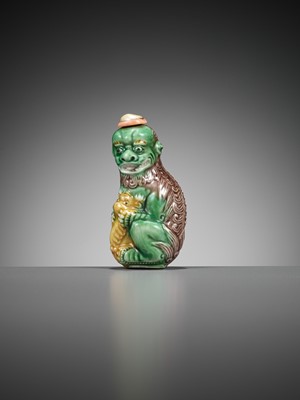Lot 387 - A MOLDED AND SANCAI-GLAZED PORCELAIN ‘LION AND CUB’ SNUFF BOTTLE, 1790-1830