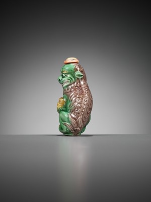 Lot 387 - A MOLDED AND SANCAI-GLAZED PORCELAIN ‘LION AND CUB’ SNUFF BOTTLE, 1790-1830