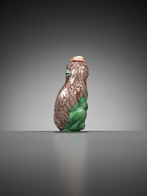 Lot 387 - A MOLDED AND SANCAI-GLAZED PORCELAIN ‘LION AND CUB’ SNUFF BOTTLE, 1790-1830