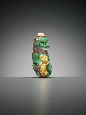 Lot 387 - A MOLDED AND SANCAI-GLAZED PORCELAIN ‘LION AND CUB’ SNUFF BOTTLE, 1790-1830