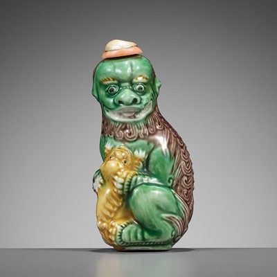 Lot 387 - A MOLDED AND SANCAI-GLAZED PORCELAIN ‘LION AND CUB’ SNUFF BOTTLE, 1790-1830