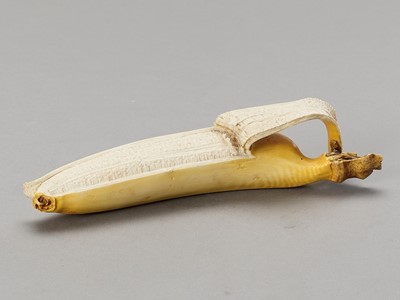 Lot 270 - A STAINED IVORY ‘TROMPE-L’OEIL’ OKIMONO OF A BANANA