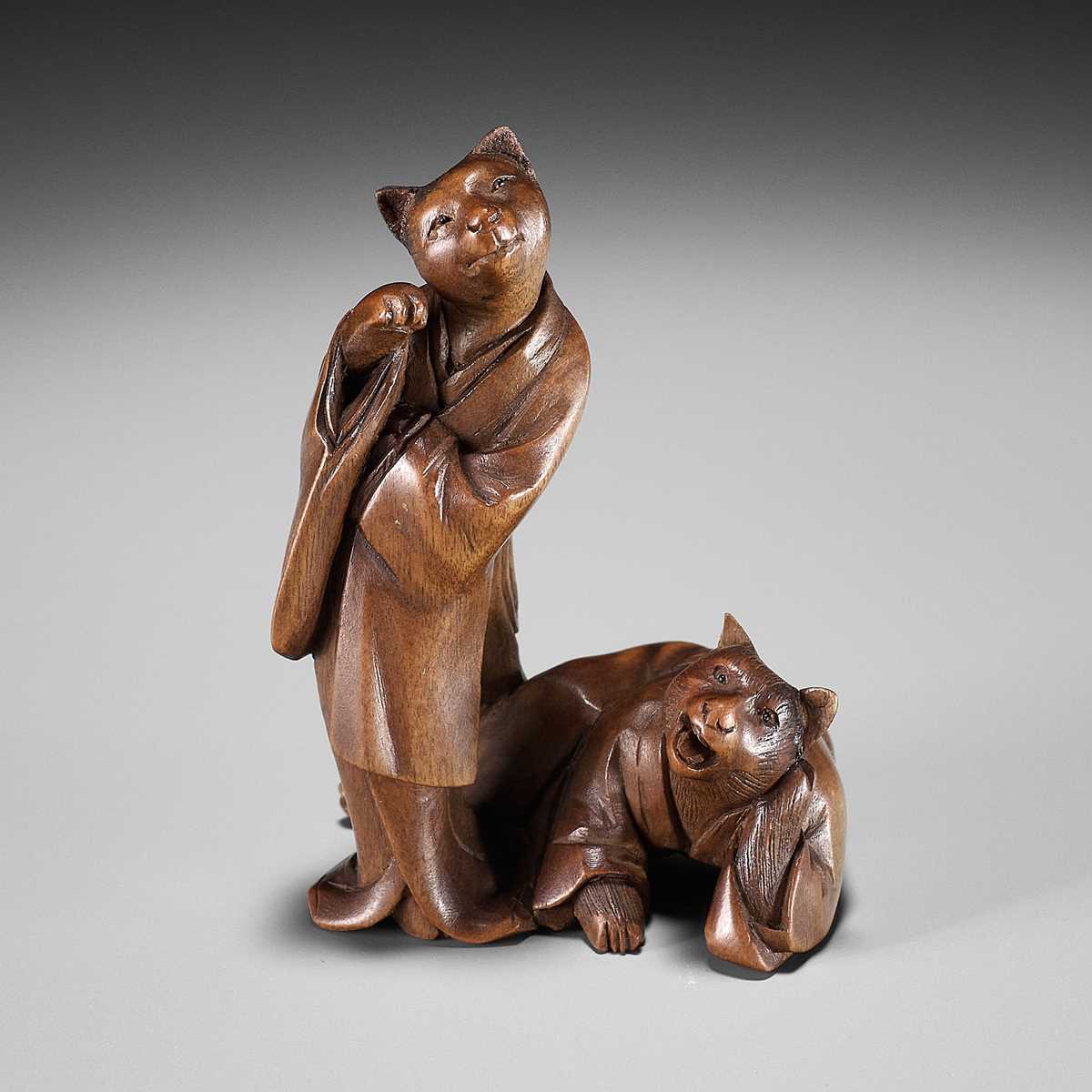 Lot 154 - A RARE WOOD NETSUKE-OKIMONO OF A CAT GEISHA AND CLIENT