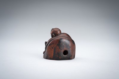 A WOOD NETSUKE OF A YAMABUSHI MONK WITH CONCH