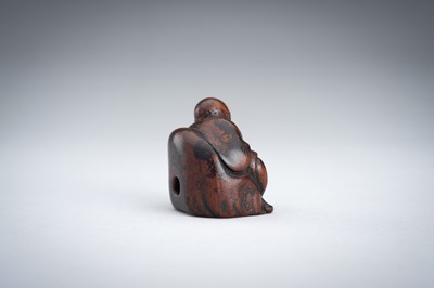 A WOOD NETSUKE OF A YAMABUSHI MONK WITH CONCH