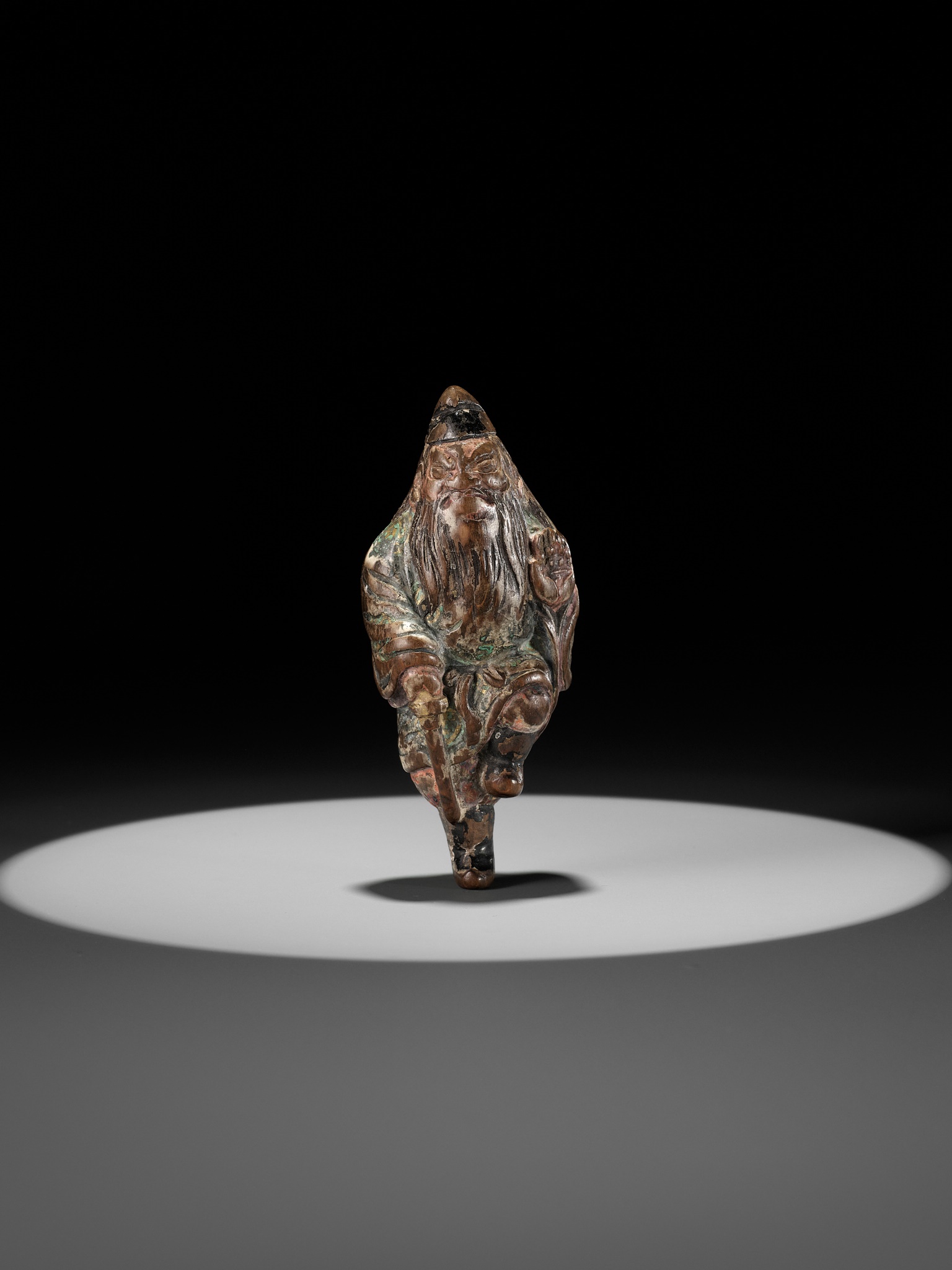Lot 114 - A SUPERB SAISHIKI NETSUKE OF SHOKI WITH HIS
