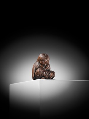 Lot 610 - TADATOSHI: A SUPERB NAGOYA SCHOOL WOOD NETSUKE OF A SLEEPING SHOJO