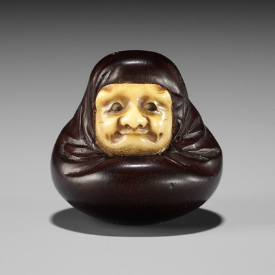 Lot 250 - IPPOSAI: AN AMUSING INLAID IVORY AND WOOD KARAKURI (TRICK) NETSUKE OF A DARUMA DOLL