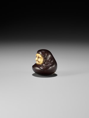 Lot 250 - IPPOSAI: AN AMUSING INLAID IVORY AND WOOD KARAKURI (TRICK) NETSUKE OF A DARUMA DOLL