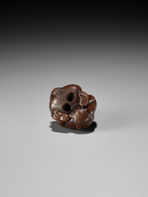 Lot 232 - GYOKUSAI: A FINE WOOD NETSUKE OF A BLIND MASSEUR LIFTING A CHIKARAISHI