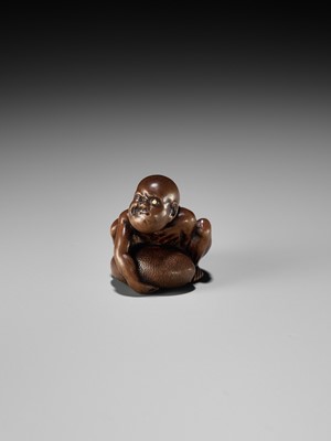 Lot 232 - GYOKUSAI: A FINE WOOD NETSUKE OF A BLIND MASSEUR LIFTING A CHIKARAISHI