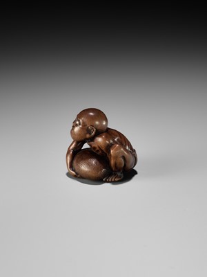 Lot 232 - GYOKUSAI: A FINE WOOD NETSUKE OF A BLIND MASSEUR LIFTING A CHIKARAISHI