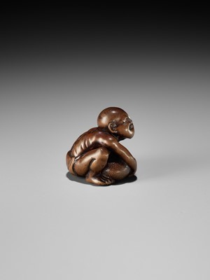 Lot 232 - GYOKUSAI: A FINE WOOD NETSUKE OF A BLIND MASSEUR LIFTING A CHIKARAISHI