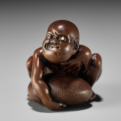 Lot 232 - GYOKUSAI: A FINE WOOD NETSUKE OF A BLIND MASSEUR LIFTING A CHIKARAISHI