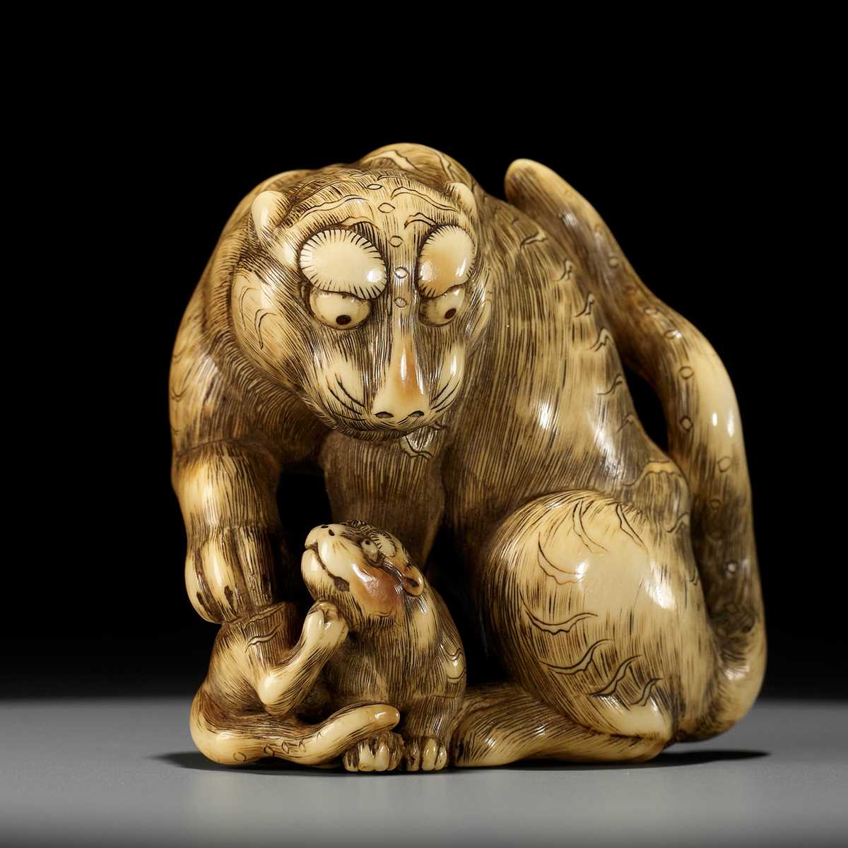 Lot 139 - A SUPERB IVORY NETSUKE OF A TIGER WITH CUB, ATTRIBUTED TO TOMOTADA