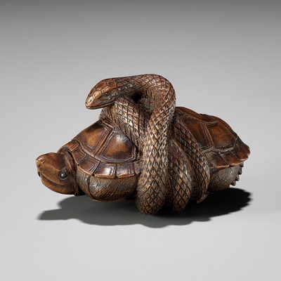 Lot 361 - A YAMADA SCHOOL WOOD NETSUKE OF A SNAKE COILED AROUND A TORTOISE