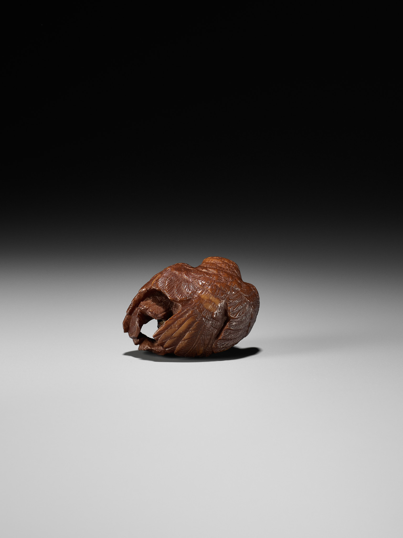Lot 467 - A COROZO NUT NETSUKE OF A HAWK AND YOUNG