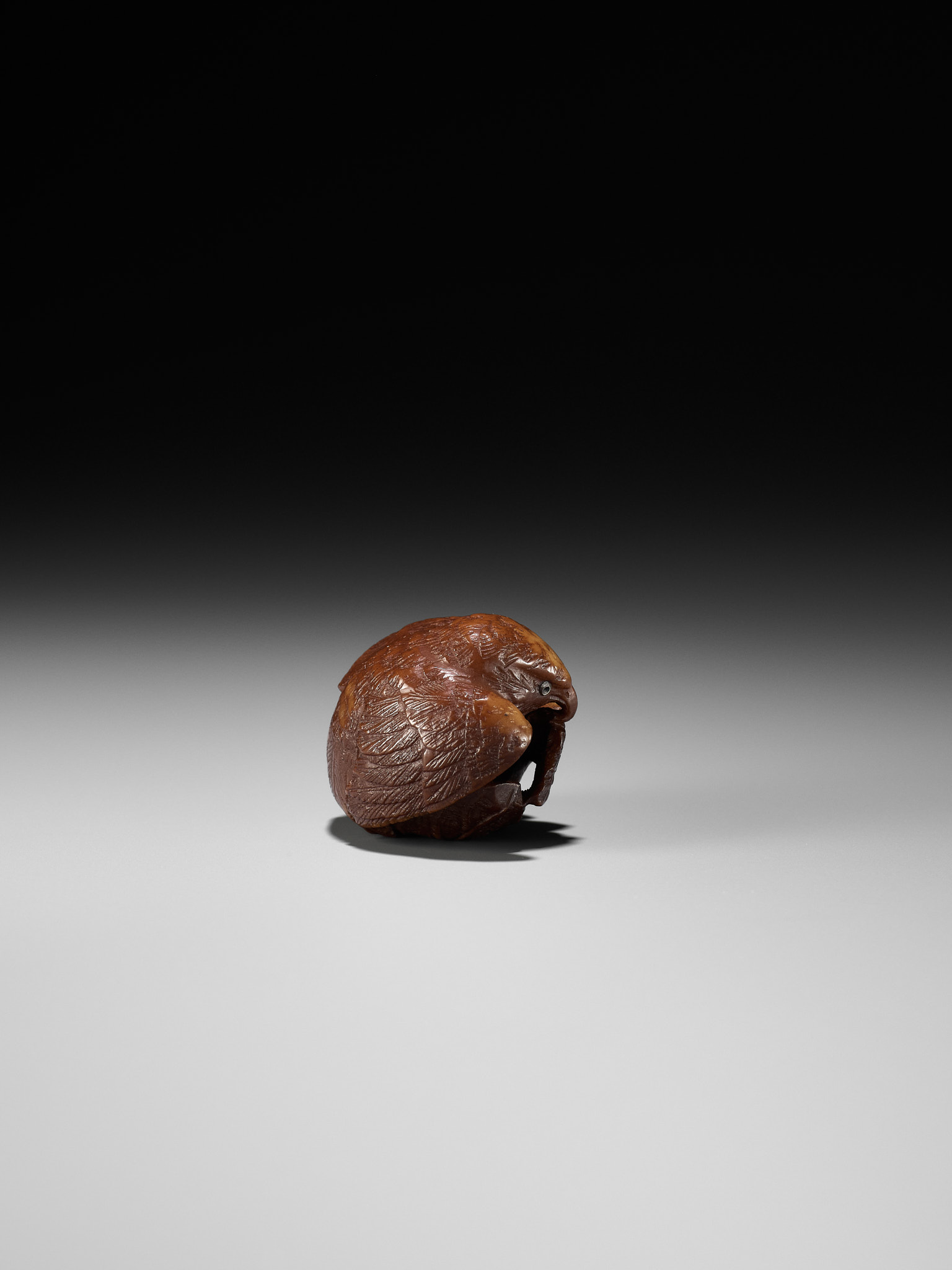Lot 467 - A COROZO NUT NETSUKE OF A HAWK AND YOUNG