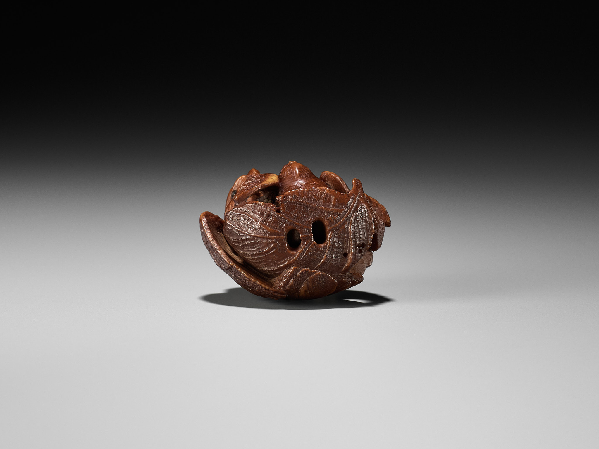 Lot 467 - A COROZO NUT NETSUKE OF A HAWK AND YOUNG