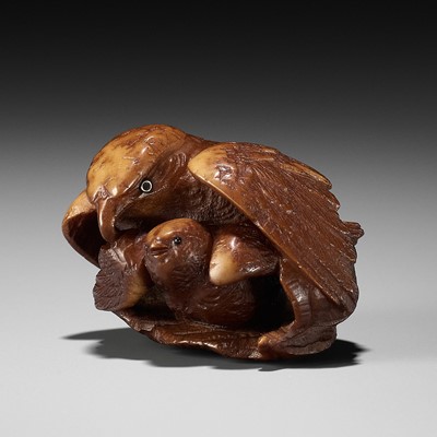 Lot 467 - A COROZO NUT NETSUKE OF A HAWK AND YOUNG