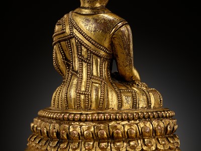 Lot 173 - A GILT-BRONZE FIGURE OF A LAMA ON A STEPPED THRONE, TIBET, 13TH - 14TH CENTURY