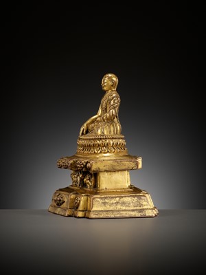 Lot 173 - A GILT-BRONZE FIGURE OF A LAMA ON A STEPPED THRONE, TIBET, 13TH - 14TH CENTURY