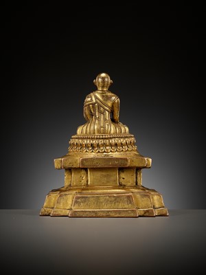 Lot 173 - A GILT-BRONZE FIGURE OF A LAMA ON A STEPPED THRONE, TIBET, 13TH - 14TH CENTURY