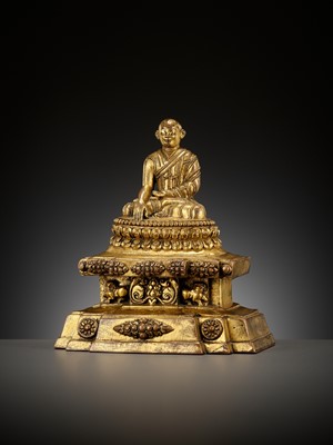 Lot 173 - A GILT-BRONZE FIGURE OF A LAMA ON A STEPPED THRONE, TIBET, 13TH - 14TH CENTURY