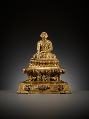 Lot 173 - A GILT-BRONZE FIGURE OF A LAMA ON A STEPPED THRONE, TIBET, 13TH - 14TH CENTURY