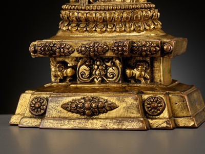 Lot 173 - A GILT-BRONZE FIGURE OF A LAMA ON A STEPPED THRONE, TIBET, 13TH - 14TH CENTURY