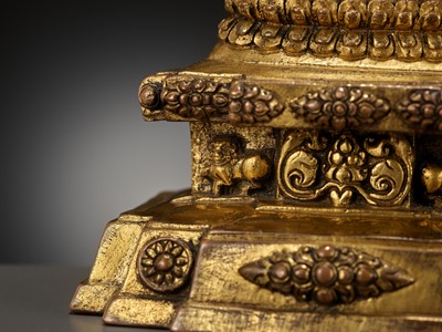 Lot 173 - A GILT-BRONZE FIGURE OF A LAMA ON A STEPPED THRONE, TIBET, 13TH - 14TH CENTURY