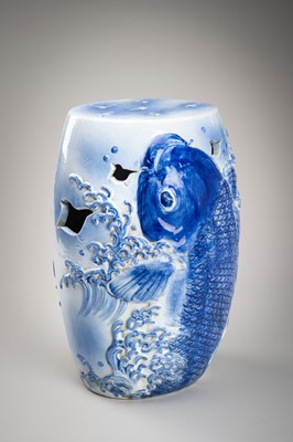 Lot 241 - A LARGE AND HEAVY BLUE AND WHITE ‘KOI’ GARDEN STOOL