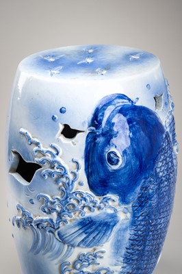 Lot 241 - A LARGE AND HEAVY BLUE AND WHITE ‘KOI’ GARDEN STOOL